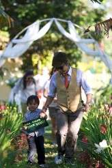 The ring bearer also carried a sign saying HERE COMES YOUR MAN
